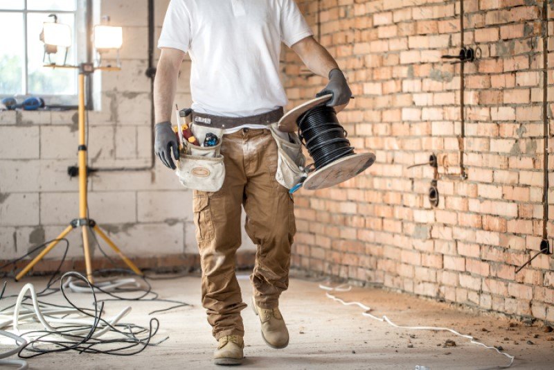 electrician-with-tools-working-construction-site-repair-handyman-concept